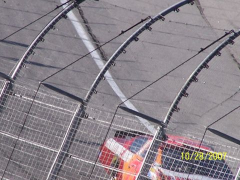 1979 Ford F-150 - A race car speeds along the track, partially obscured by a safety fence. The date 10/28/2007 is visible.