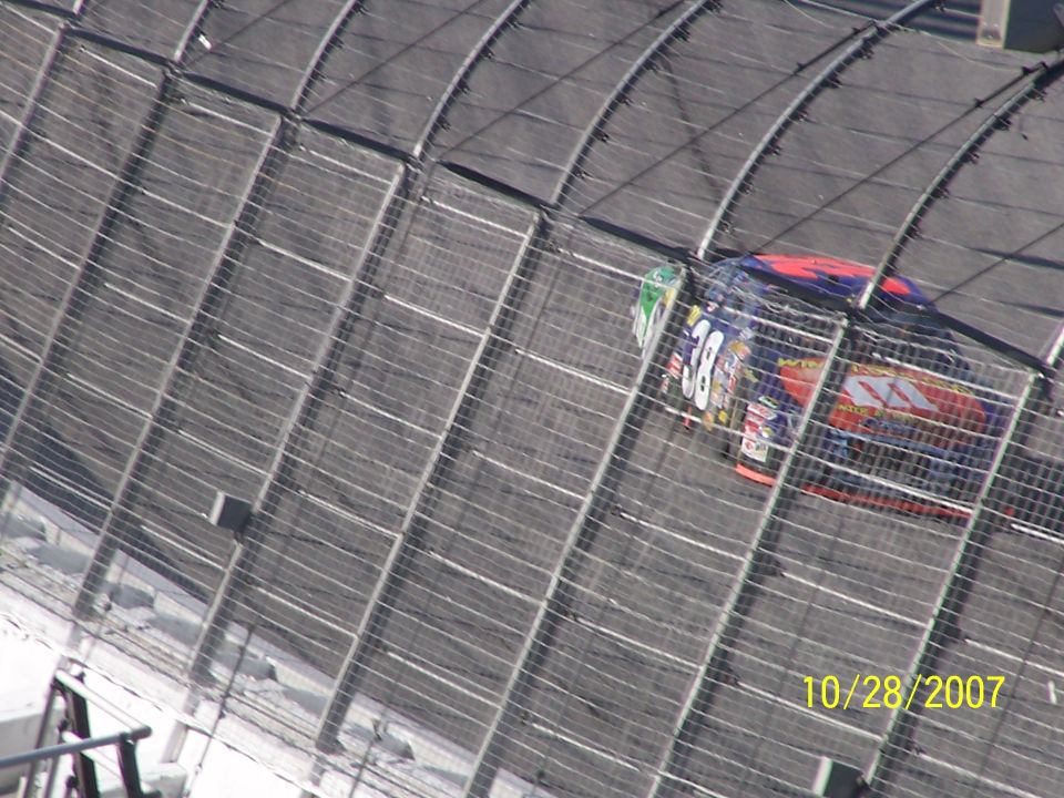 Race car with number 38 on its side, viewed from above on a track