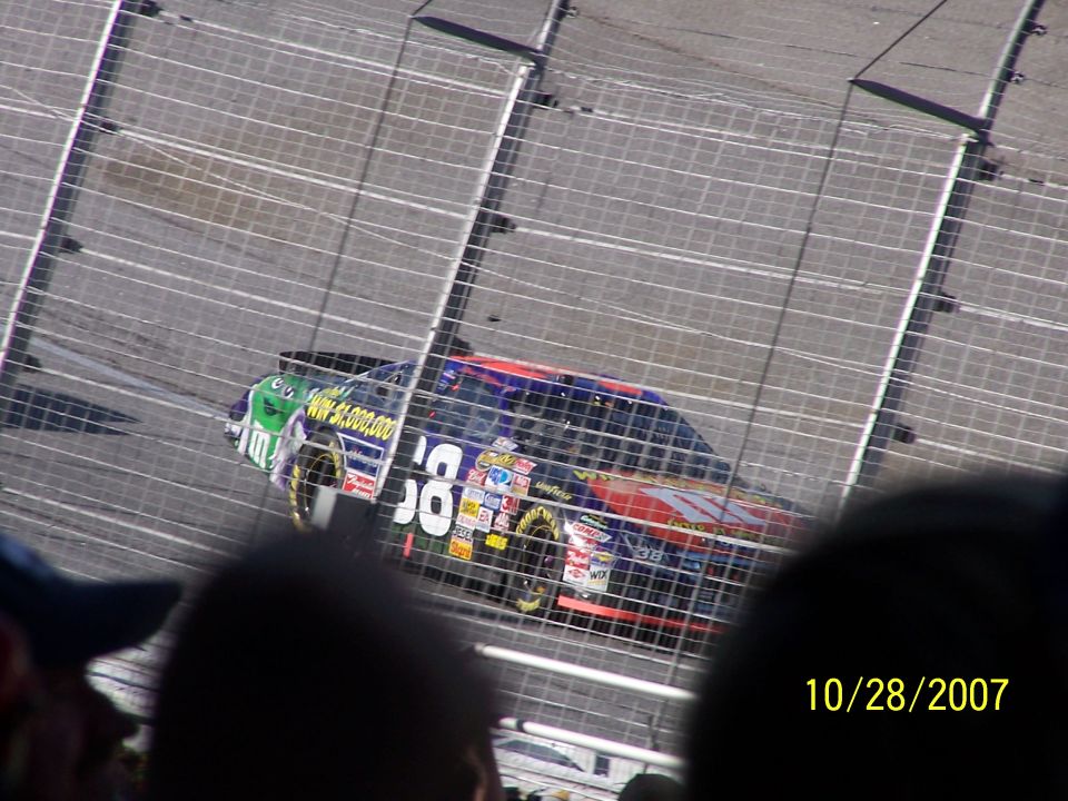 Race car with number 58 and various sponsor decals on a track
