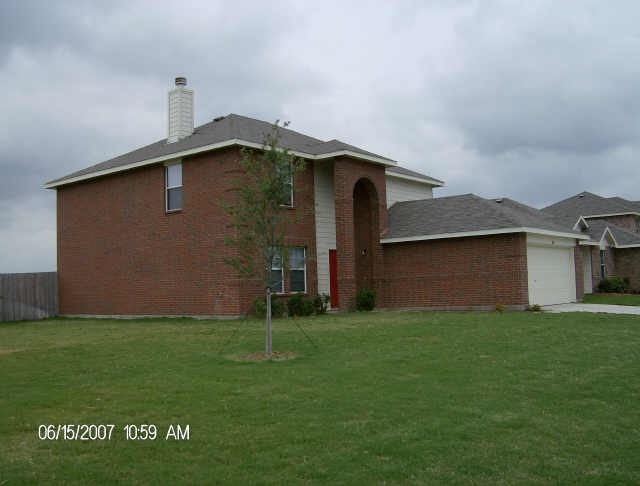 Brick house with garage and lawn