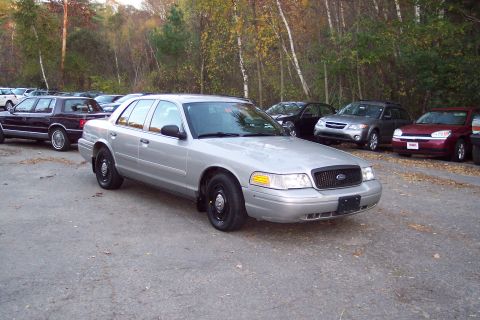 2001 Ford Crown Victoria - Silver 2001 Ford Crown Victoria sedan parked outdoors with trees in the background.