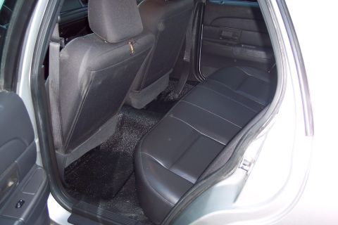 2001 Ford Crown Victoria - The interior of the vehicle shows the rear seats and floor area.