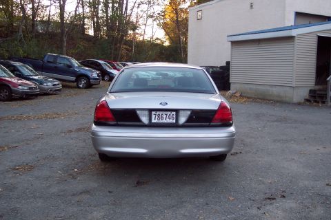 2001 Ford Crown Victoria - Rear view of a silver 2001 Ford Crown Victoria parked outdoors.