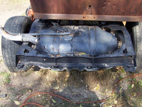 1995 Ford Bronco - The underside of a vehicle, focusing on the fuel tank and suspension components.