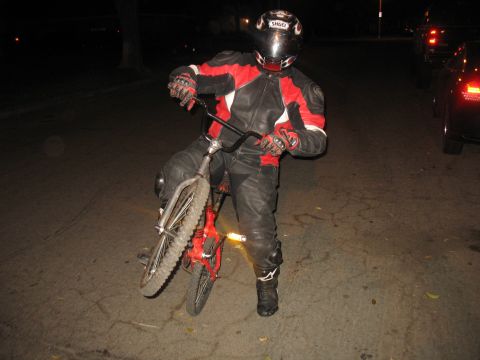2007 Yamaha R1 - Rider in full gear on a bicycle at night.