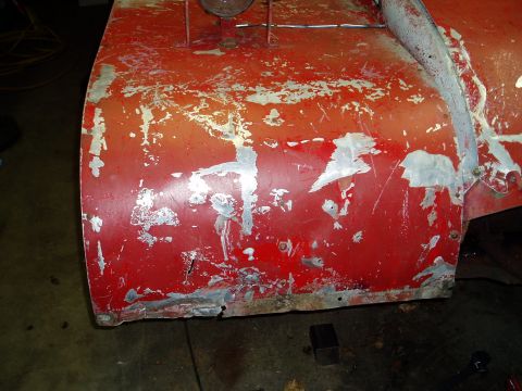 2000 Ford E350 - Red snow blower housing shows significant wear and tear with metal repairs evident.