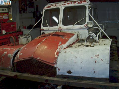 2000 Ford E350 - This snow vehicle appears to be in a garage or workshop, showing signs of age and wear.
