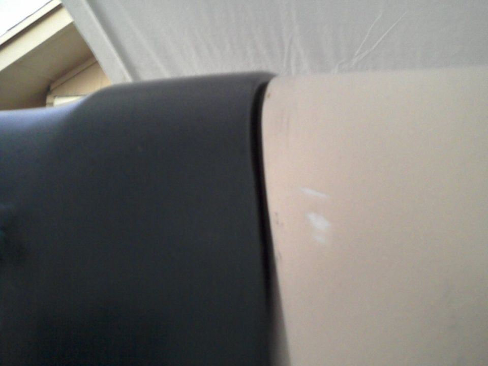 Close-up of black trim next to a cream panel