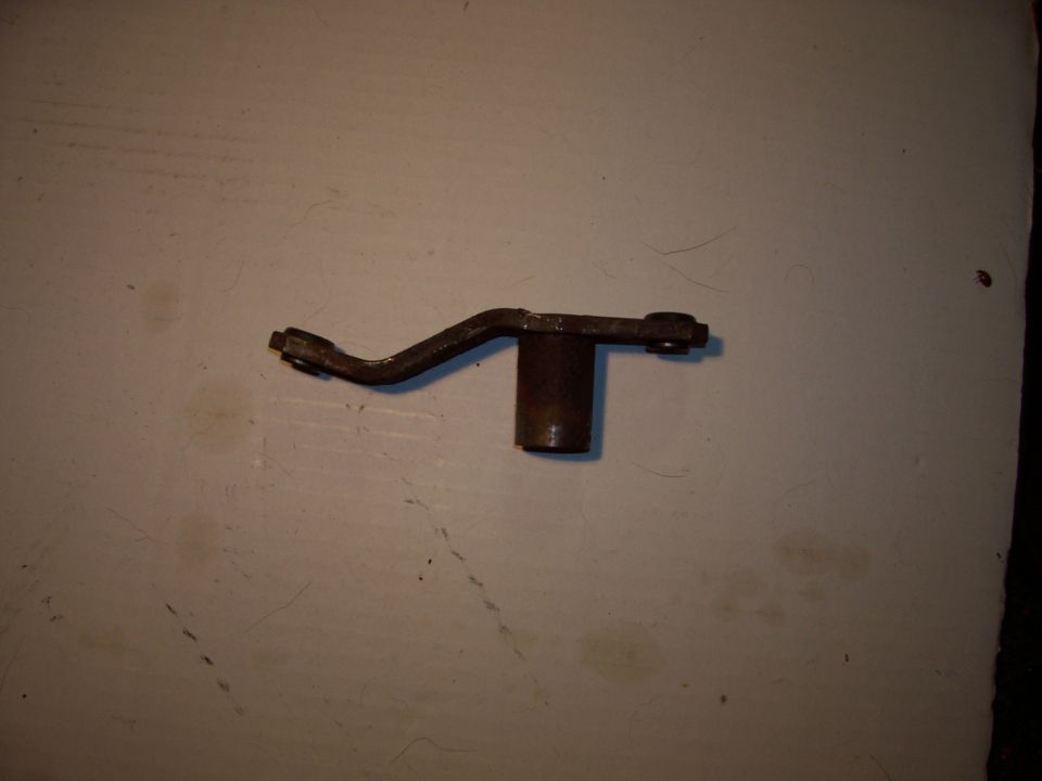 metal linkage with two pivot points and a cylindrical base
