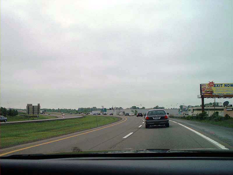Dark sedan from rear on highway, 2000 Ford Crown Victoria