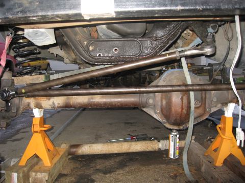 1990 Ford F-250 - The underside of a 1990 Ford F-250 reveals its robust front axle and steering linkage.