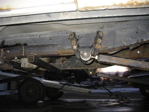 1990 Ford F-250 - Custom suspension modifications are visible on the undercarriage of a truck, with a trailer underneath.
