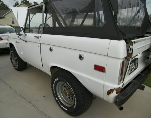 1974 Ford Bronco - This 1974 Ford Bronco is shown with its hood up, parked next to another vehicle.