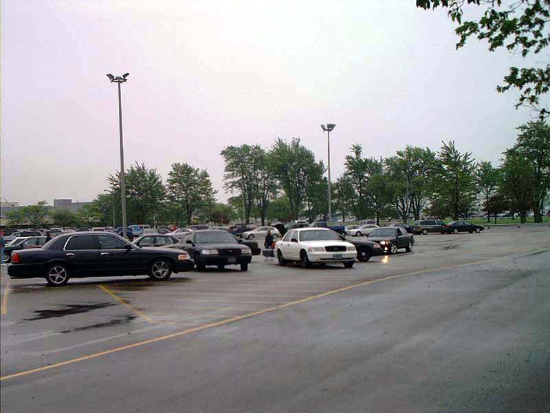 Black 2000 Ford Crown Victoria parked in a lot, viewed from the front-right