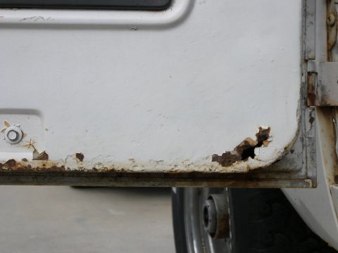 1974 Ford Bronco - Rust damage is visible on the lower edge of this vehicle's door panel.