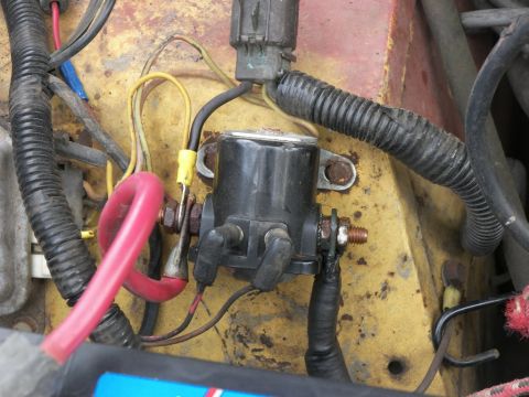 1974 Ford Bronco - Close-up view of a starter solenoid and associated wiring, including a prominent red battery cable.