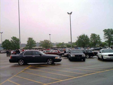 2000 Ford Crown Victoria - A black 2000 Ford Crown Victoria is seen from a three-quarter front view in a parking lot with other vehicles.