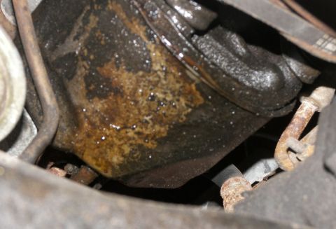 1974 Ford Bronco - Engine oil pan shows signs of leakage and corrosion.