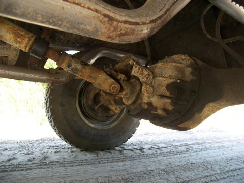 1974 Ford Bronco - Close-up view of the driveshaft and rear differential assembly on a vehicle.