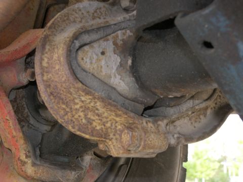 1974 Ford Bronco - This close-up shows a heavily rusted suspension component, likely from the underside of a vehicle.