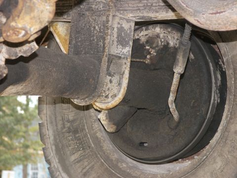 1974 Ford Bronco - Close-up view of a vehicle's rear drum brake assembly and suspension components.