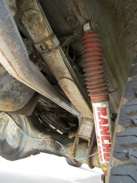 1974 Ford Bronco - Vehicle undercarriage with leaf springs and a Rancho shock absorber is visible.