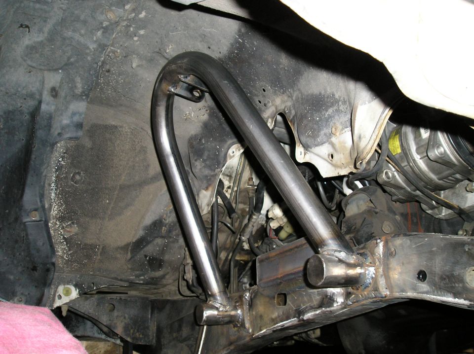 Fabricated bare-metal tube loop welded to vehicle frame rail, underside view