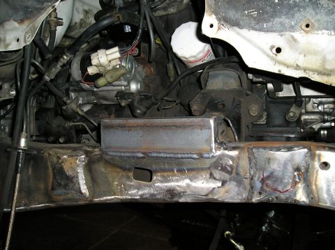 1986 Toyota Hilux - Close-up of a custom metal fabrication on a vehicle's chassis, showing welding work.