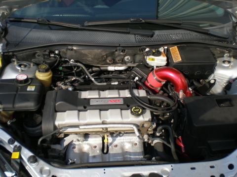 2003 Ford Focus - The engine bay of a 2003 Ford Focus SVT shows a custom red intake and other engine components.
