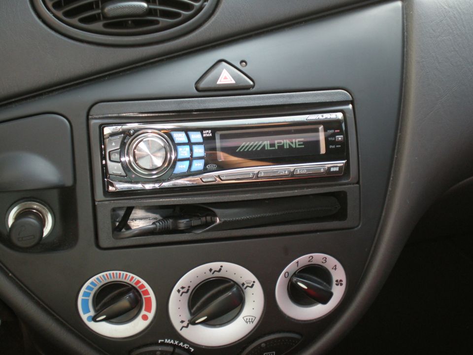 Interior view of a 2003 Ford Focus dashboard with an Alpine stereo and climate controls
