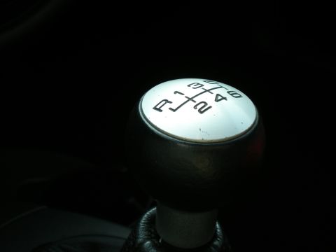 2003 Ford Focus - Close-up of a manual transmission shift knob showing the gear pattern.