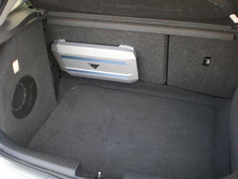 2003 Ford Focus - The trunk of a car is shown with custom audio equipment installed.
