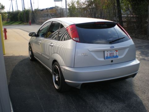 2003 Ford Focus - Rear view of a silver 2003 Ford Focus hatchback with a custom license plate.