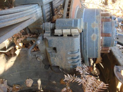 1996 Ford Bronco - A detailed view of a vehicle's brake system components, including the caliper, rotor, and leaf springs.