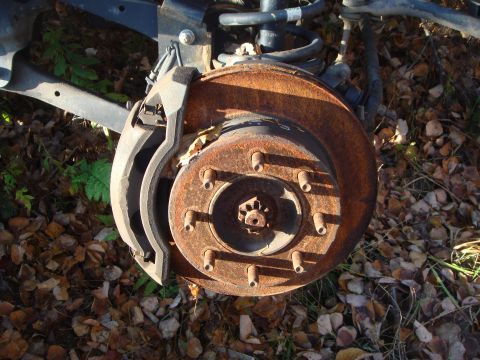 1996 Ford Bronco - This is a close-up of a heavily rusted brake rotor and caliper, likely from a vehicle's front or rear suspension.