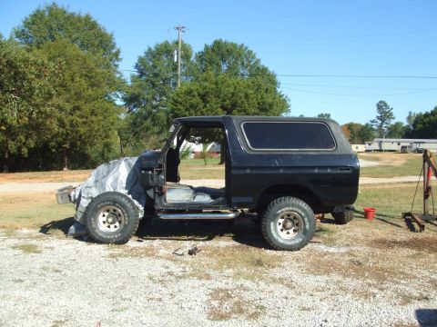 1979 Ford Bronco - This Ford Bronco appears to be undergoing restoration or repair, with its front end covered and doors removed.
