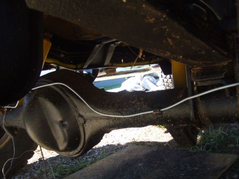 1979 Ford Bronco - Undercarriage view focuses on the rear differential and suspension system of a vehicle.