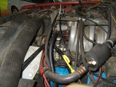 1989 Ford Bronco - Close-up view of a vehicle's engine compartment, showing various components and hoses.