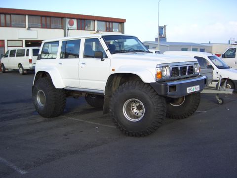 1996 Ford Bronco - This modified SUV features massive tires, significantly altering its stance and off-road capability.