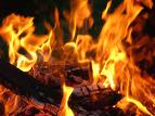 2001 Dodge 2500 - A campfire burns with bright orange flames and glowing embers.