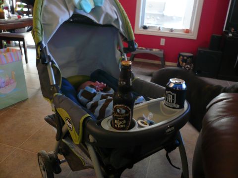 1996 Ford Probe - A baby is in a stroller with a bottle of beer and a can of soda on the tray.