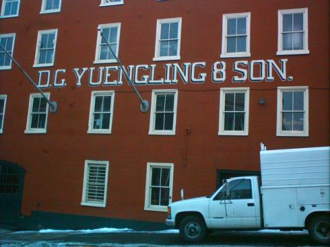 1996 Ford Probe - A white utility truck is parked in front of the D.C. Yuengling & Son building.