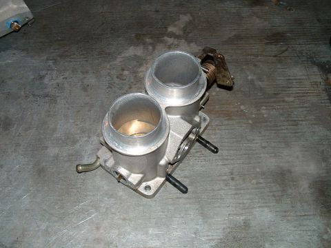 1995 Ford Bronco - Close-up of a dual throttle body assembly, likely for an engine upgrade or custom build.