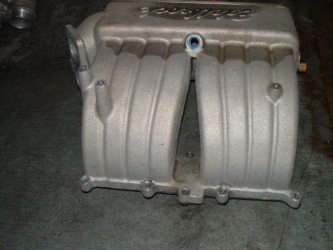 1995 Ford Bronco - Edelbrock intake manifold shown on a flat surface.