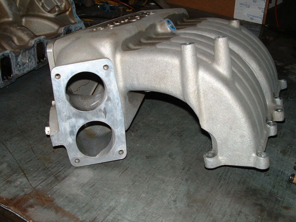 aluminum intake manifold with two bolt holes on the left flange