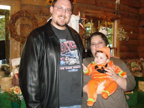 2000 Ford Crown Victoria - Family celebrates Halloween indoors with fall-themed decorations and costumes.