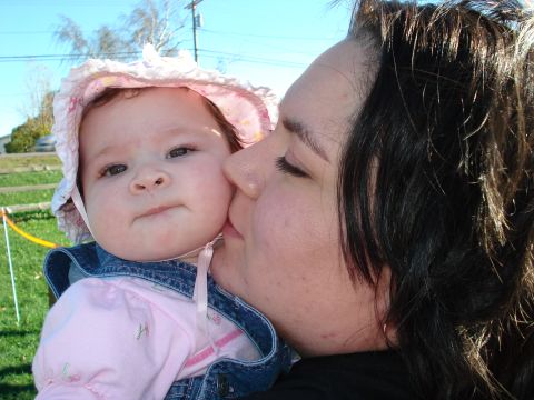 2000 Ford Crown Victoria - A tender moment captured between a mother and her child on a sunny day.