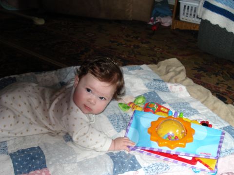 2000 Ford Crown Victoria - A baby lies on a blanket, looking towards the camera.