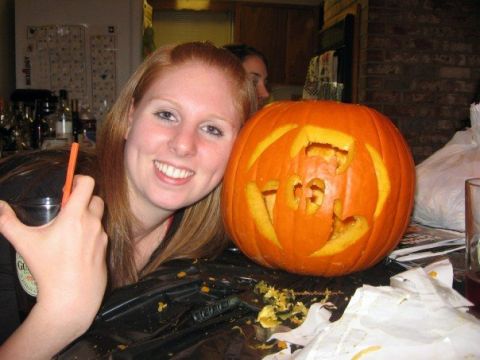 1989 Ford Bronco - A woman poses with a carved pumpkin during what appears to be a Halloween celebration.
