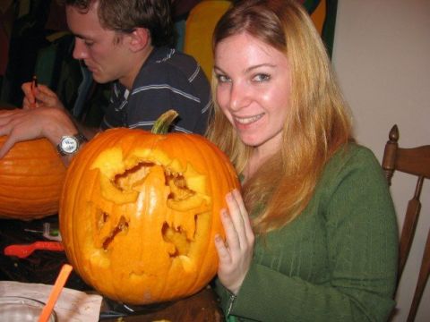 1989 Ford Bronco - Two people are carving pumpkins for Halloween. One pumpkin has a spooky face.